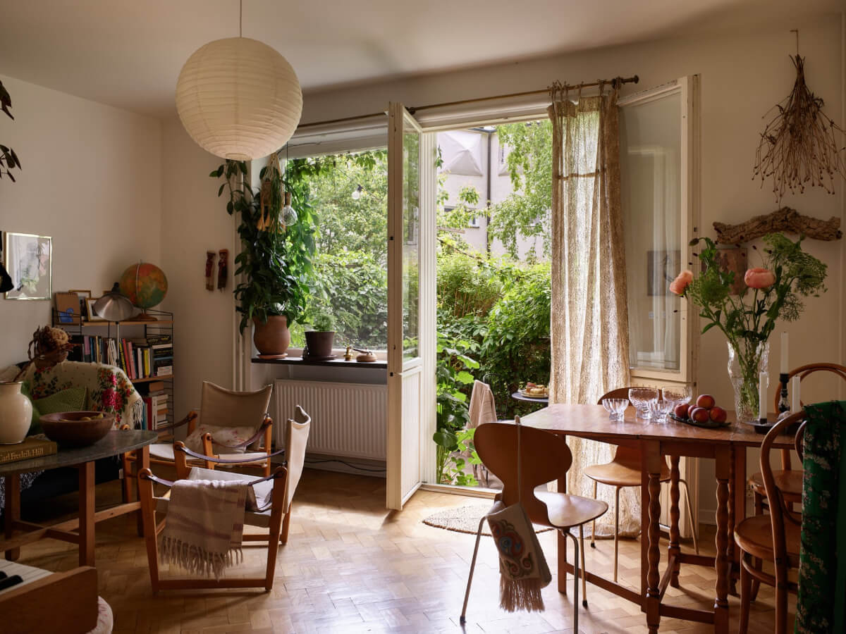 A Small Vintage Apartment with a Tiny Green Patio Garden 1 small living room parquet floor door to tiny garden