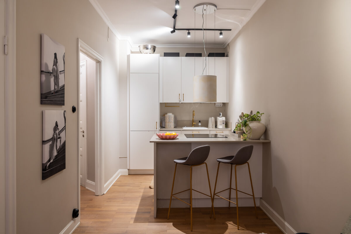 A Tiny and Luxurious Apartment in Stockholm 8 small white kitchen with island