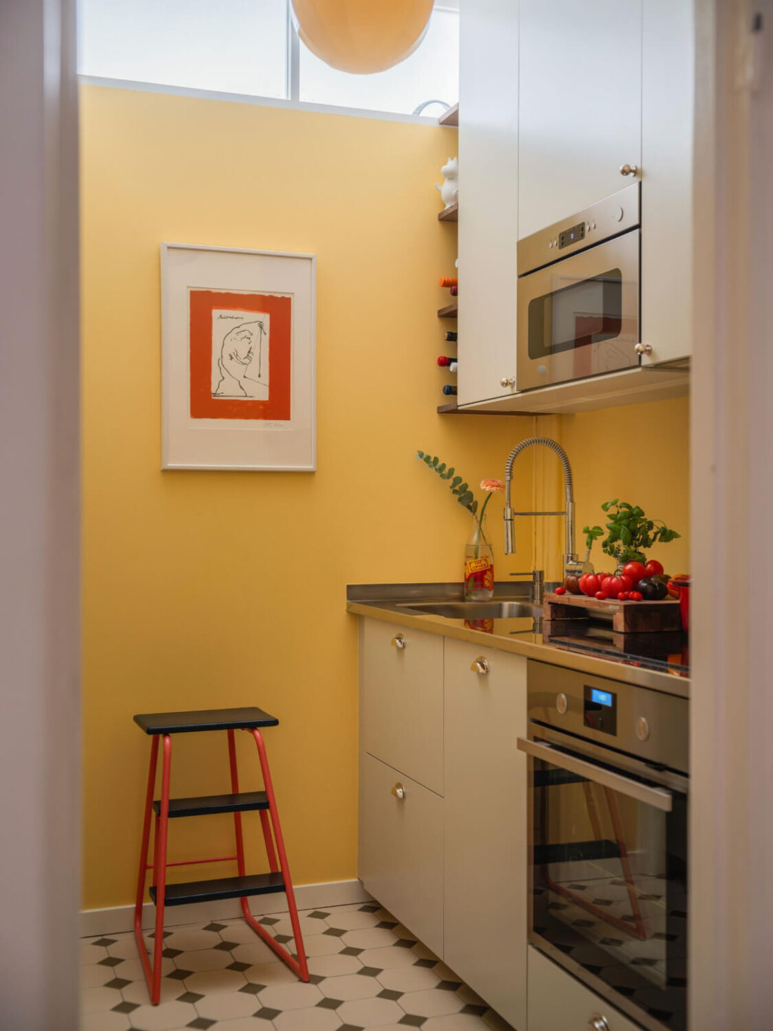 An Airy One-Bedroom Apartment with Art and A Yellow Kitchen 20 tiny kitchen light gray cabinets yellow walls