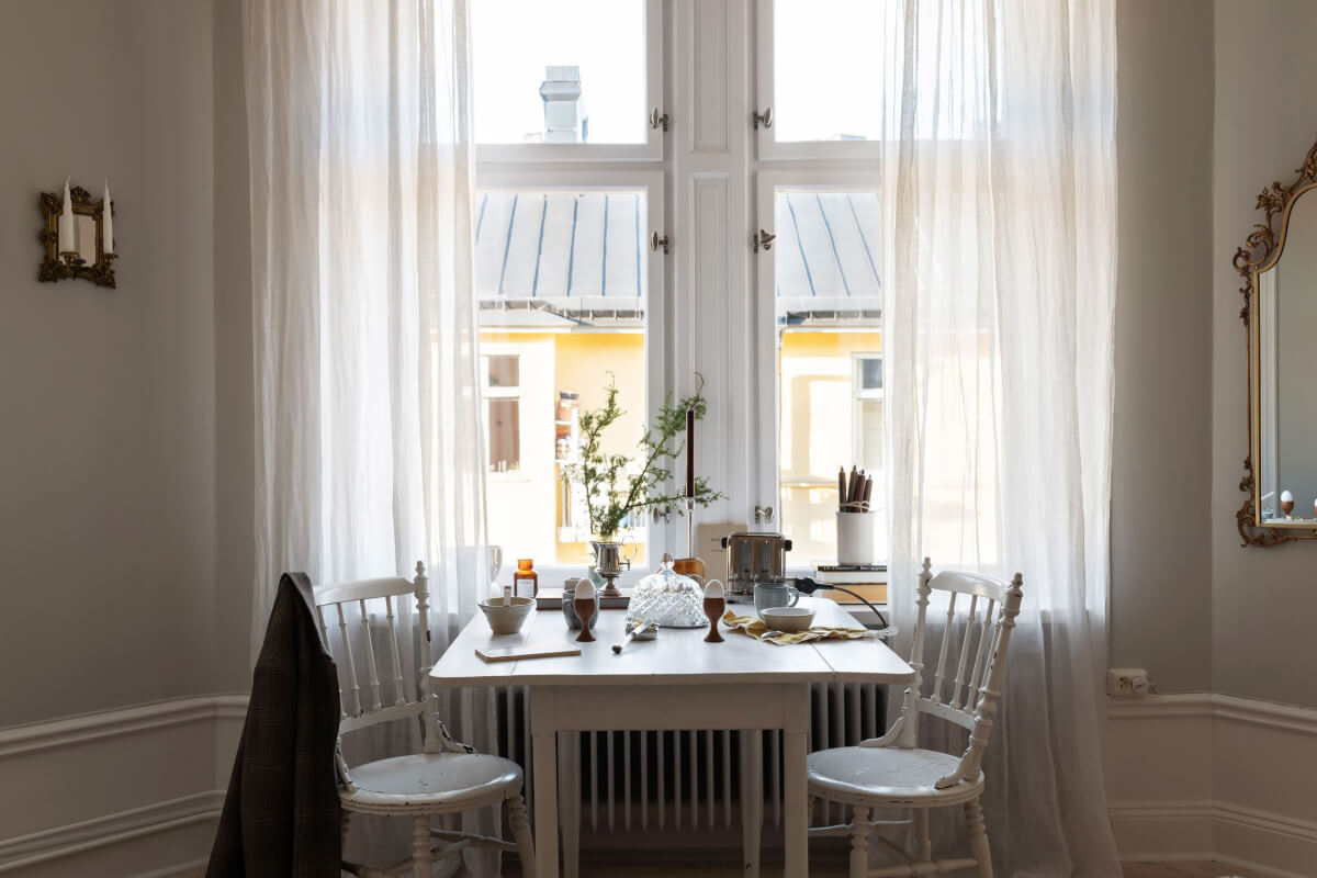 A Small Light Gray Apartment with Period Features 11 vintage table under window