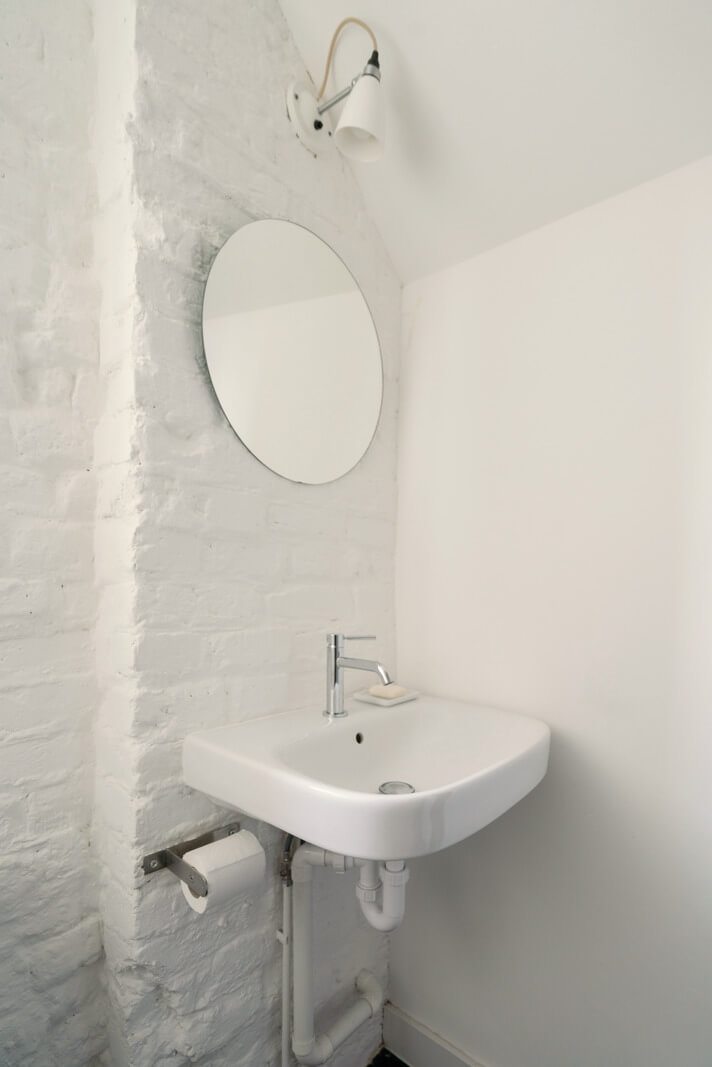 A Light One-Bedroom Apartment in a Victorian Terrace House 18 white painted brick wall bathroom