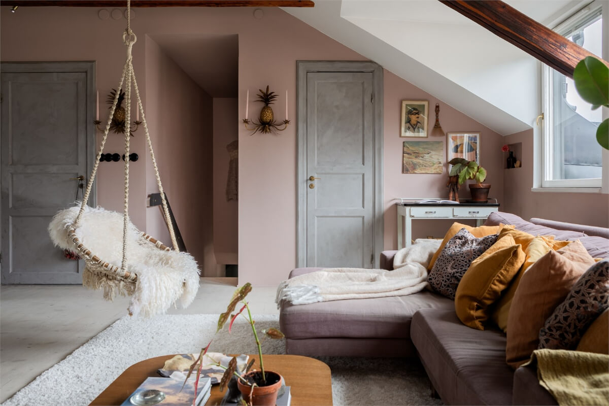 A Colorful Family Attic Apartment in Stockholm 3 attic living room hanging chair pink walls