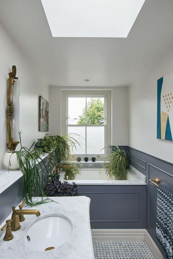 A Renovated Early Victorian Townhouse Decorated in Green Tones 16 bathroom with skylight and blue woodwork