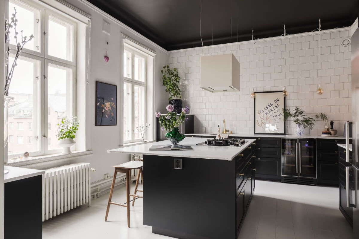 Grand Rooms and Period Features in a Malmö Apartment 13 black kitchen with island and black ceiling