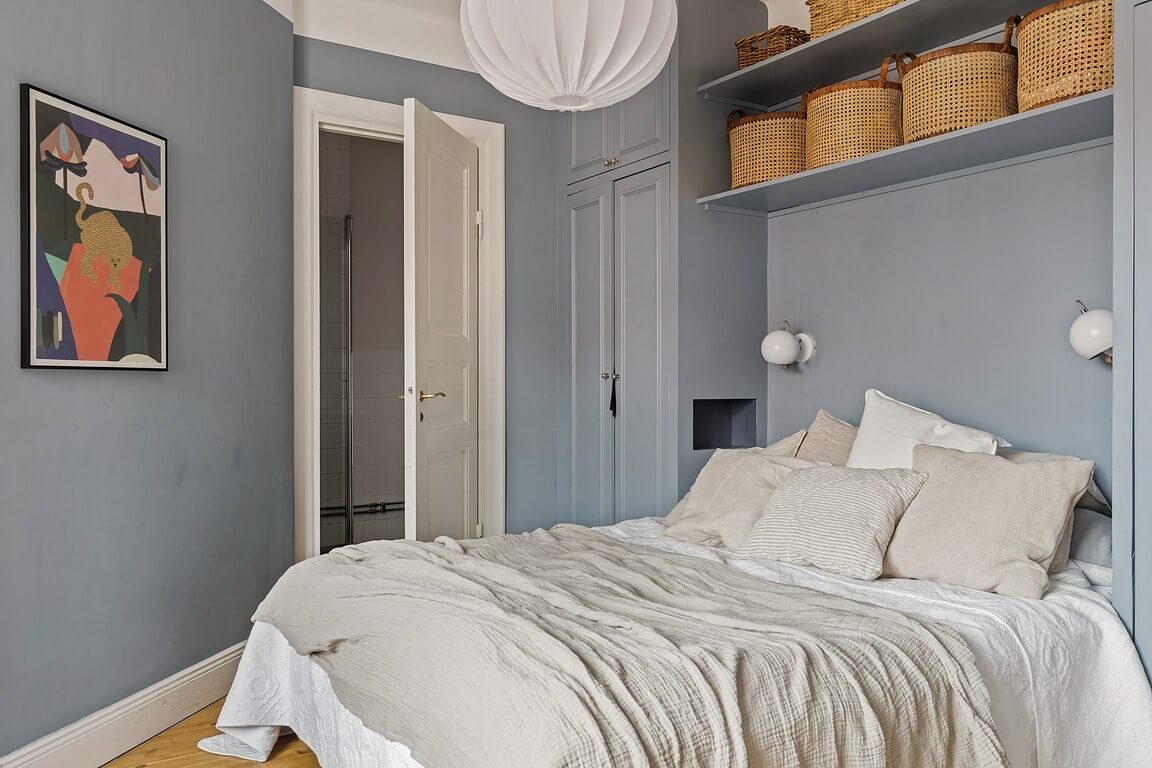 A Stockholm Apartment with a Light Yellow Kitchen 17 blue bedroom built-in wardrobe and shelves
