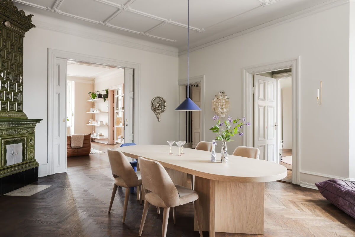 Grand Rooms and Period Features in a Malmö Apartment 10 dining room green fireplace blue pendant