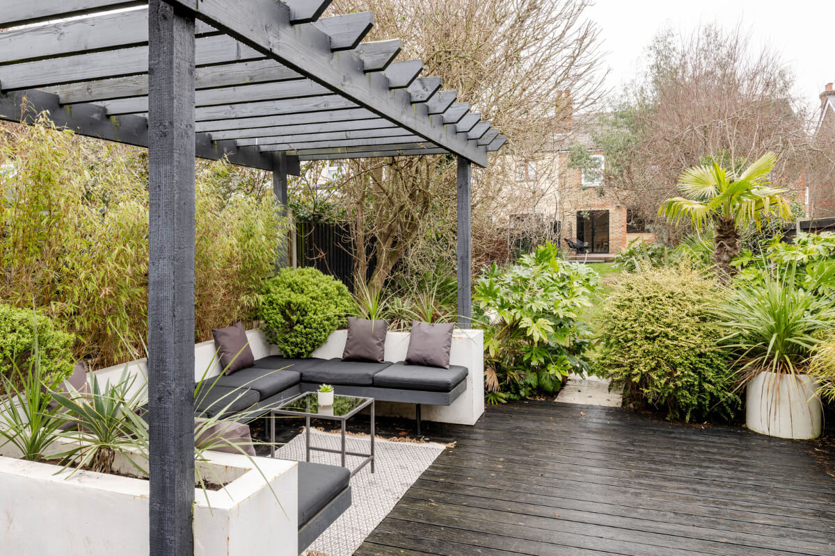 A Contrasting Color Palette in a Renovated Terrace House 19 garden pergola seating area