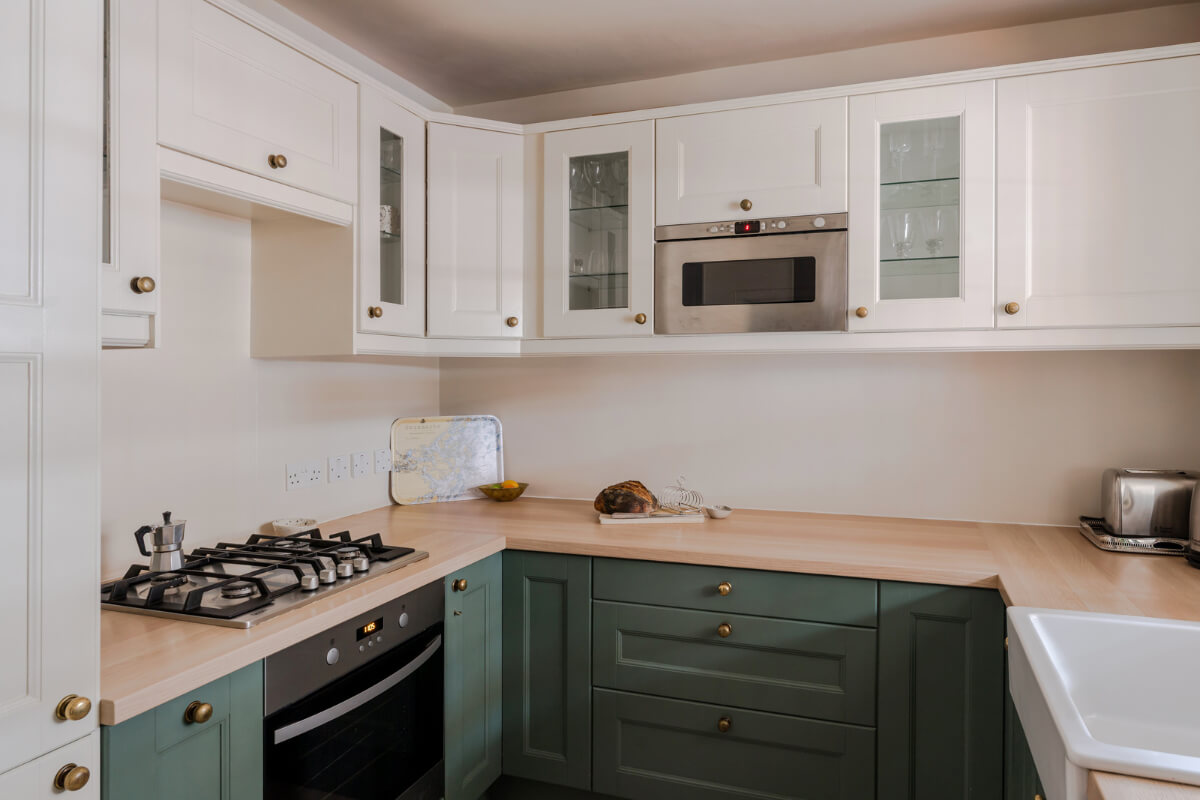 A Calm & Stylish Color Palette in a Small London Apartment 10 green and white kitchen brass knobs