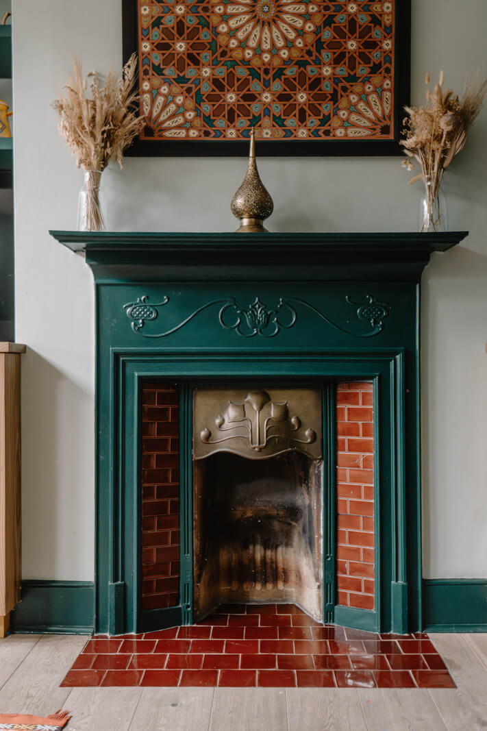 Moroccan-Inspired Designs in a Unique Artist Family Home in London 15 green fireplace red tiles