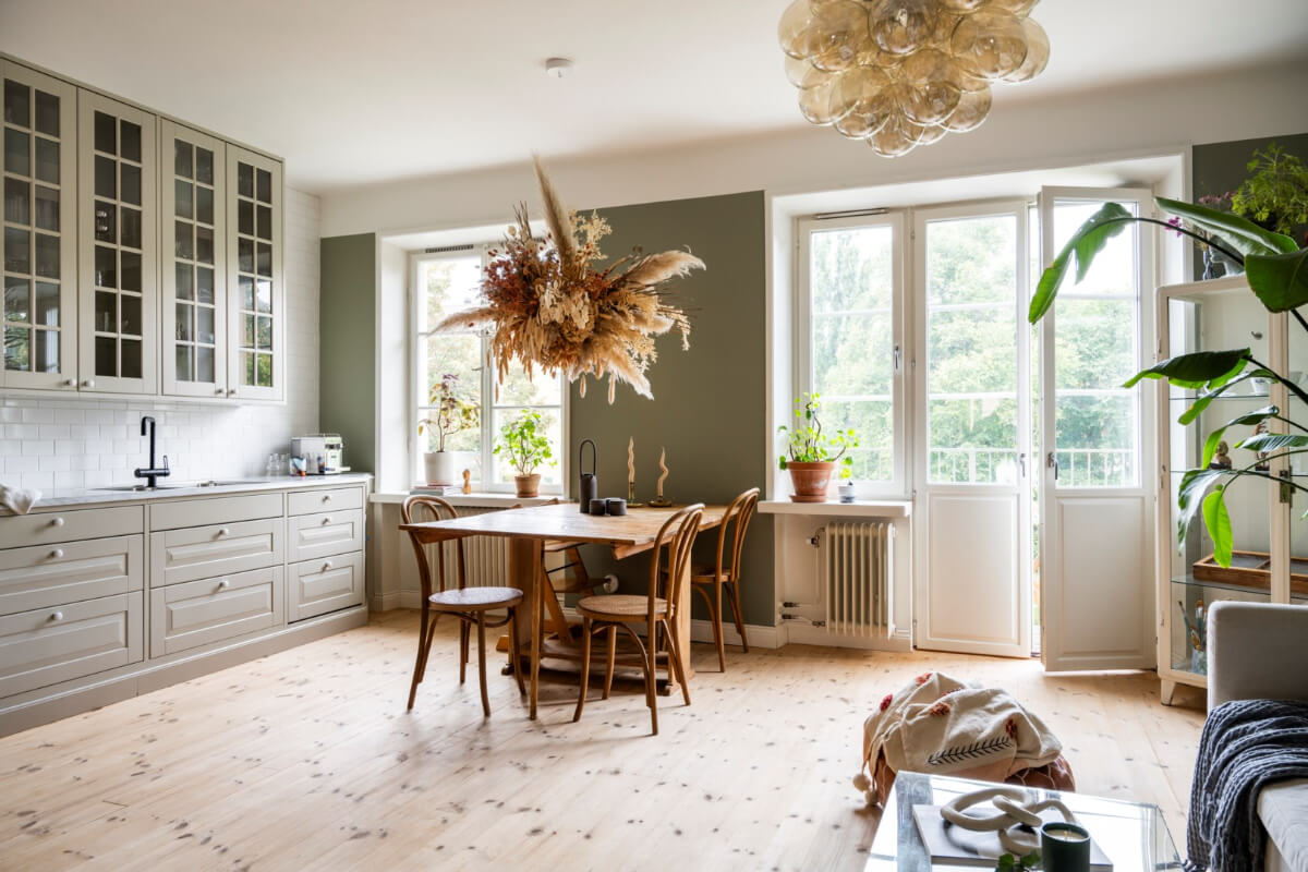 A Light Swedish Apartment with a Green Living Room 4 green open plan living space wooden floor
