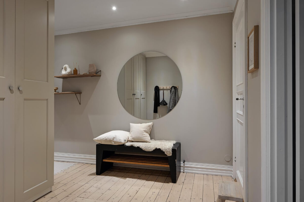 A Gothenburg Apartment with a Small Dark Green Bedroom 25 hallway built-in storage large round mirror