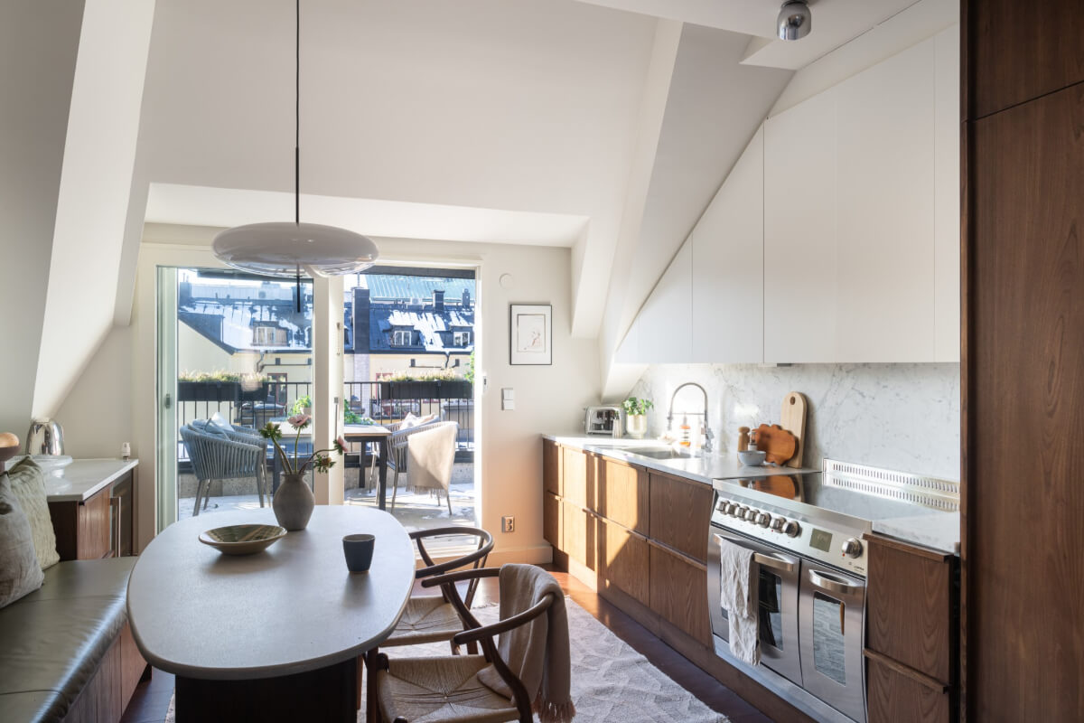 A Light Penthouse Apartment with Built-In Bookshelves 11 kitchen slanted ceiling balcony