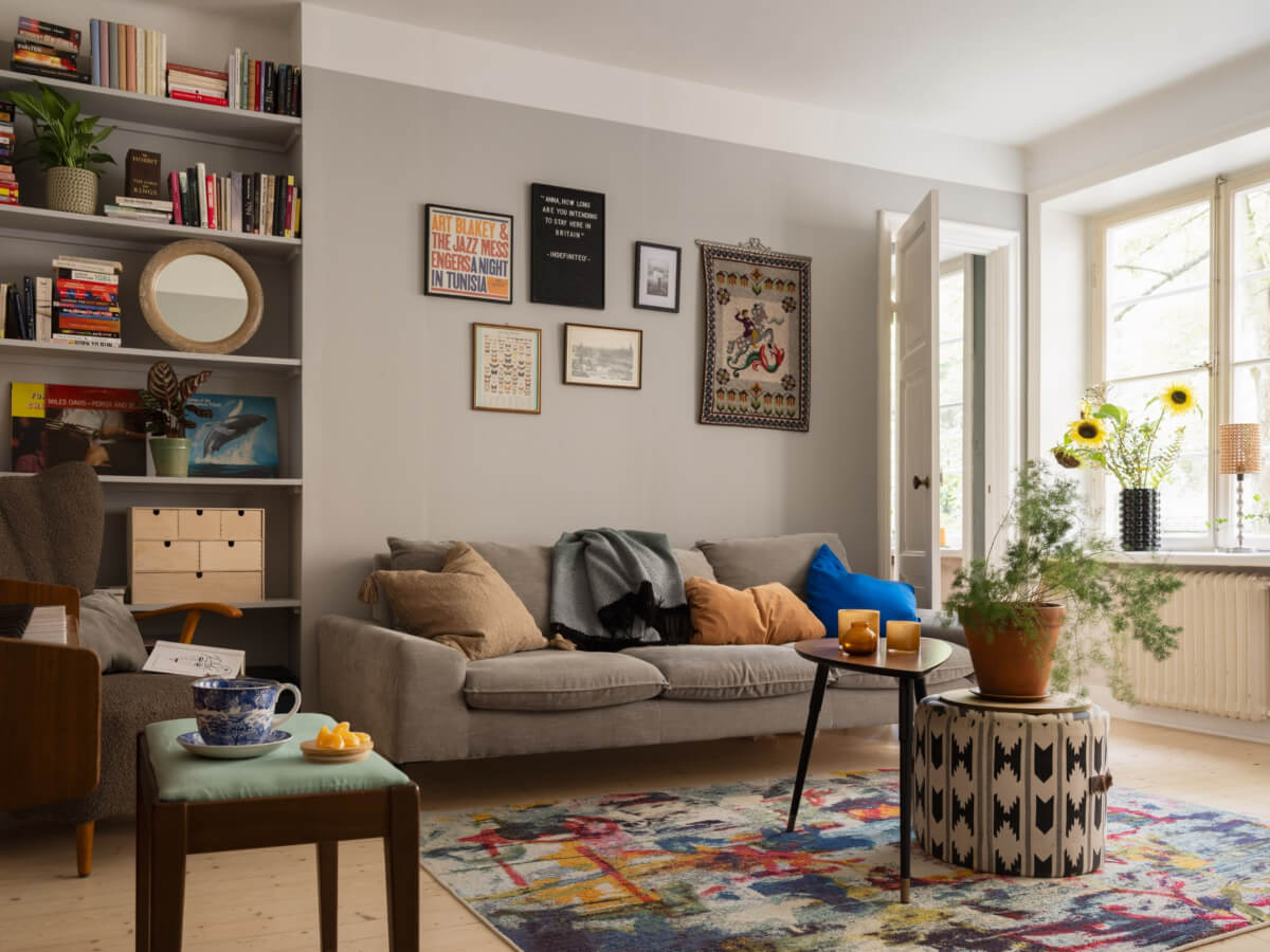 A Charming One-Bedroom Apartment in a 1920s Building 1 light gray living room colorful rug