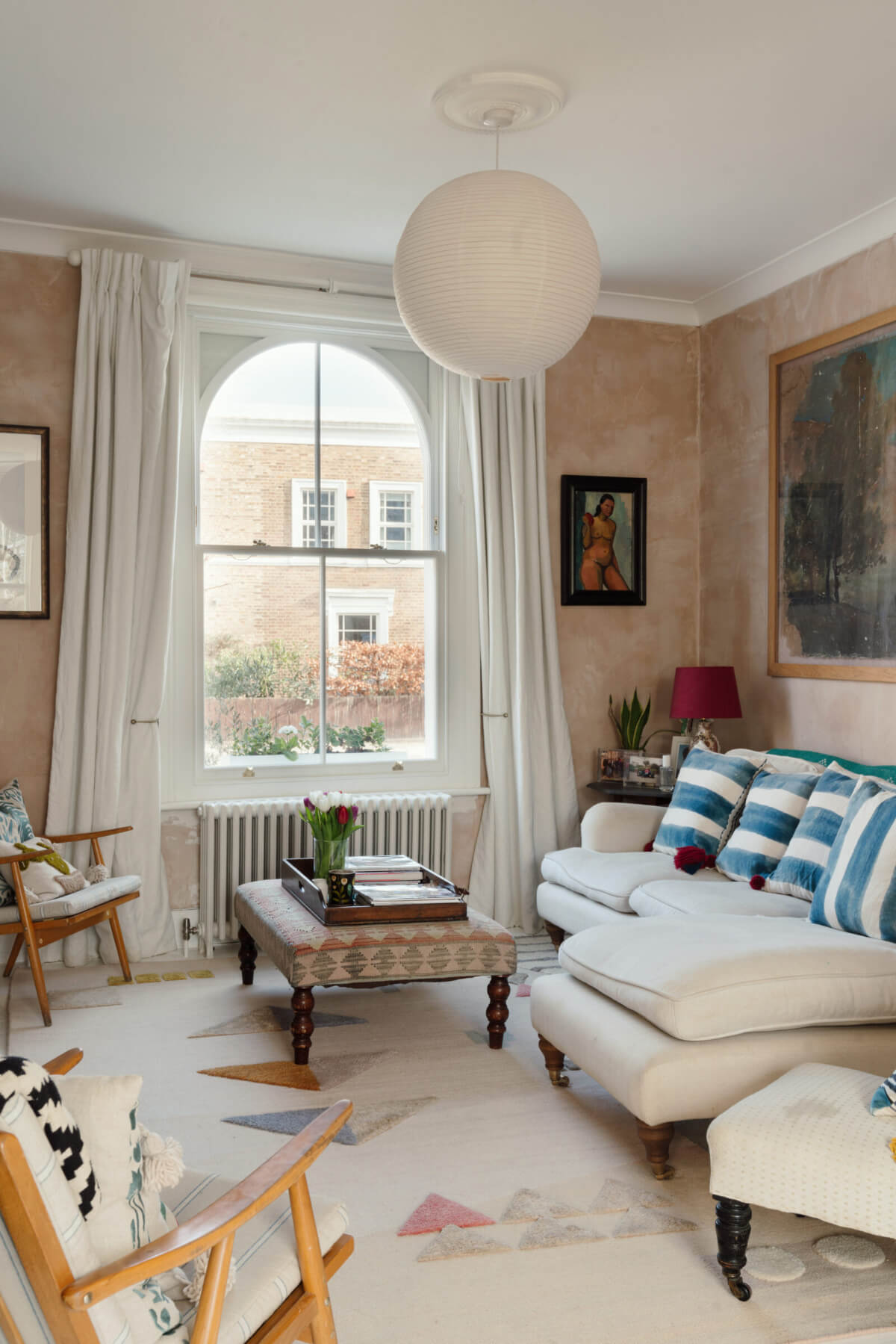 living room arched window pink plaster walls