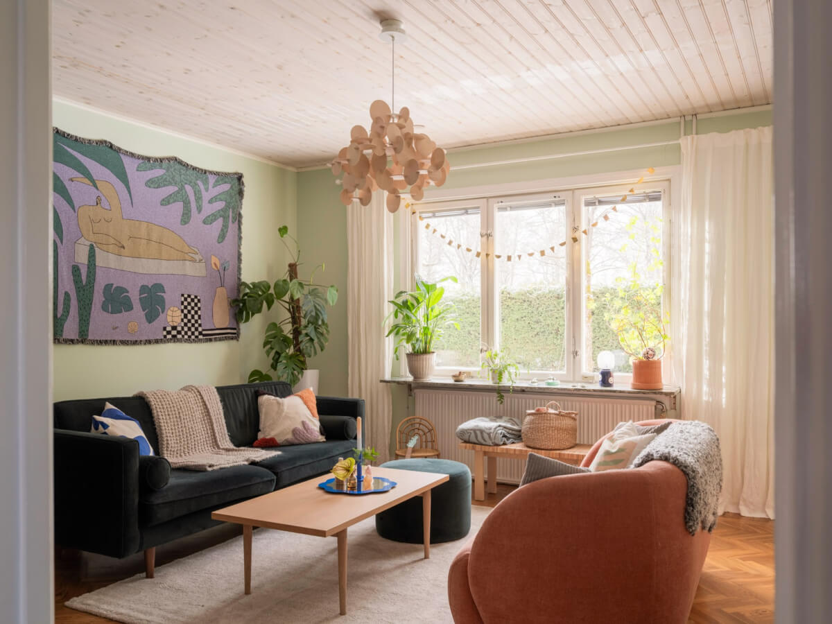Colorful Decor in a Charming Family Duplex Apartment in Stockholm 1 living room herringbone floor green walls