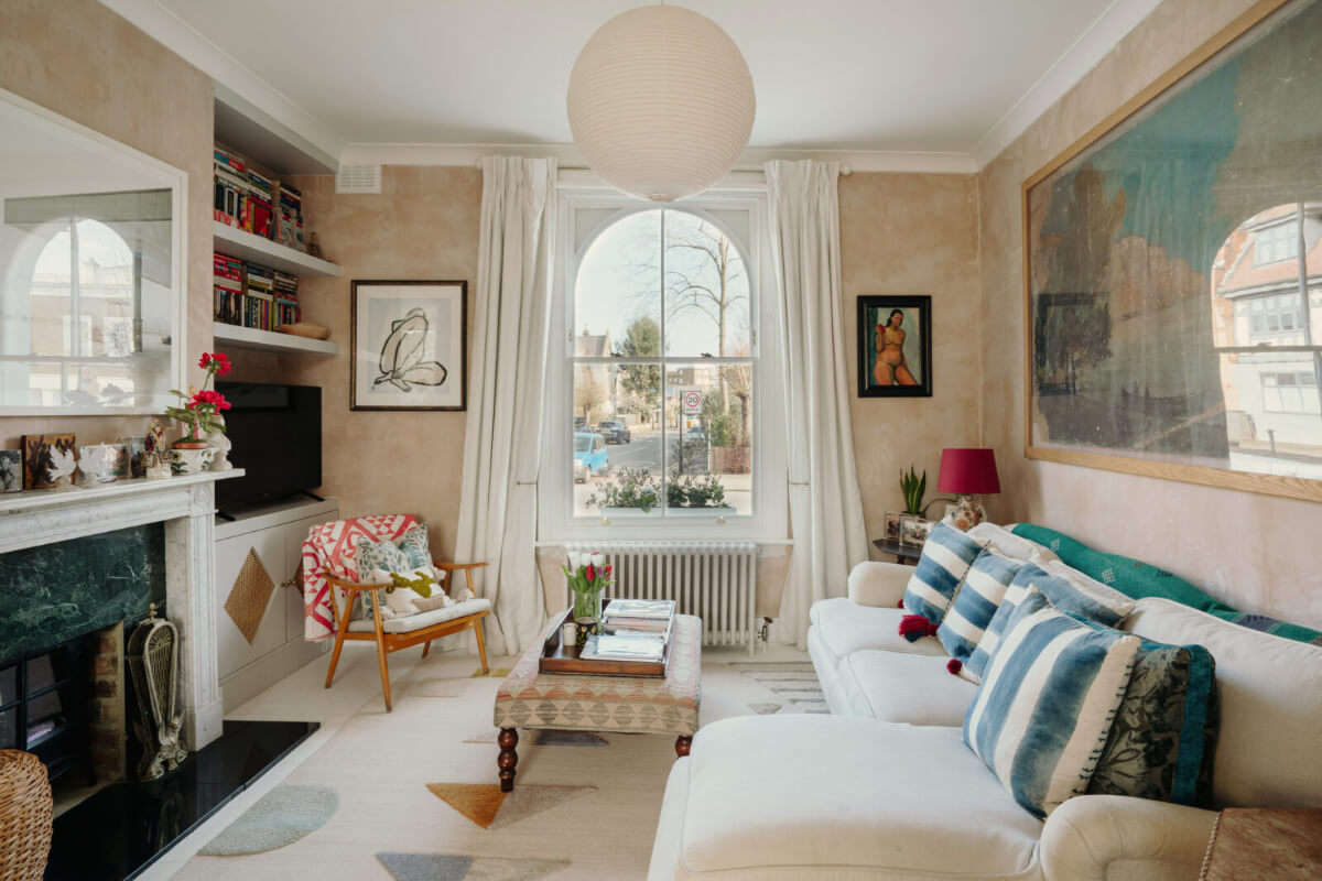 A Bright Victorian House with Plaster Walls and Blue Rooms 3 living room plaster wall arched window fireplace
