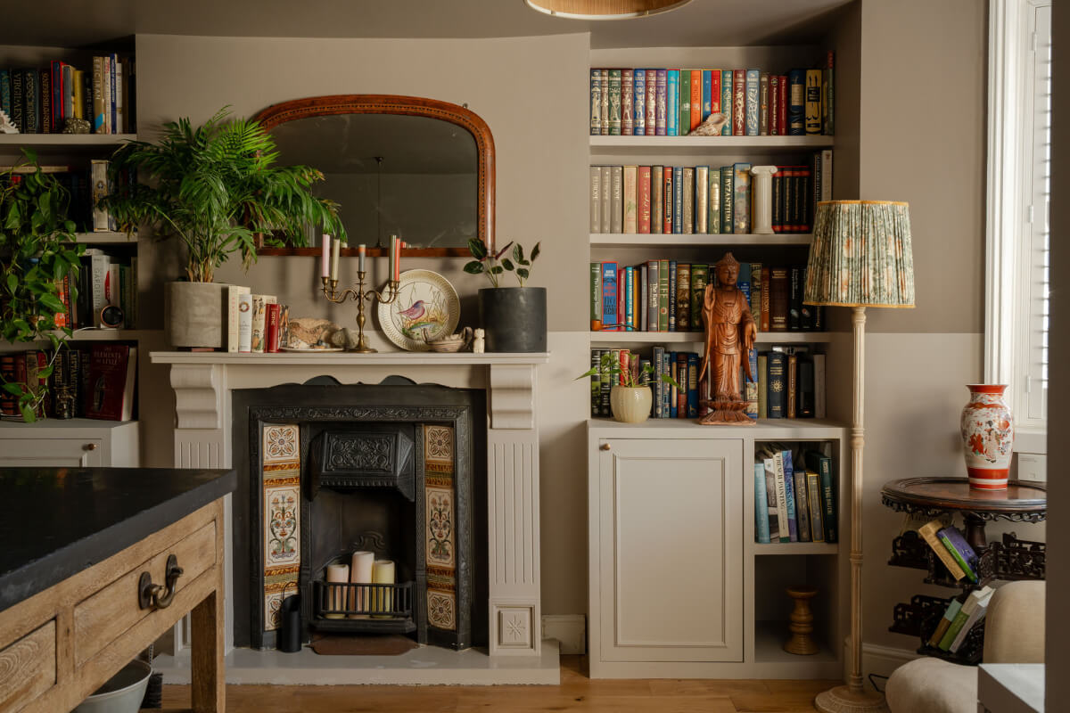A Muted Color Palette in a Charming Ground Floor Apartment 1 muted colored sitting room fireplace bookshelves