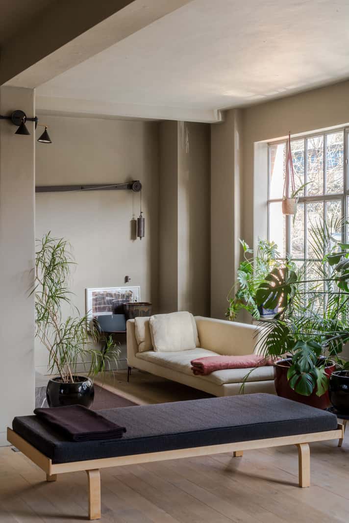 Soft-Colored Contemporary Interiors in a Warehouse Apartment 2 plant-filled sitting area