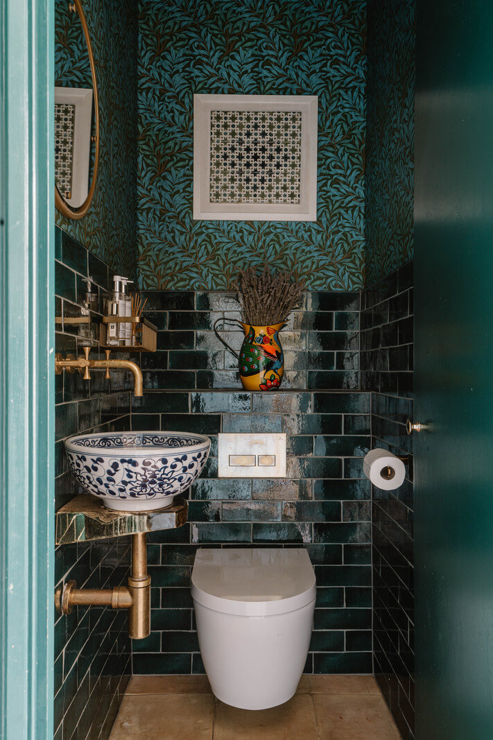 Moroccan-Inspired Designs in a Unique Artist Family Home in London 20 powder room green tiles painted sink