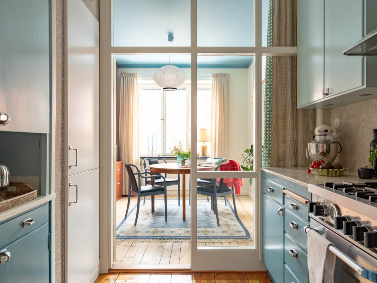 A Beautiful Well-Preserved 1930s Apartment with a Blue Kitchen 1 vintage kitchen blue cabinets glass doors dining room