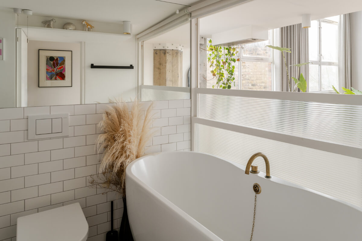 A Plant-Filled Loft Apartment in a Former Clothing Factory 12 white bathroom with bath