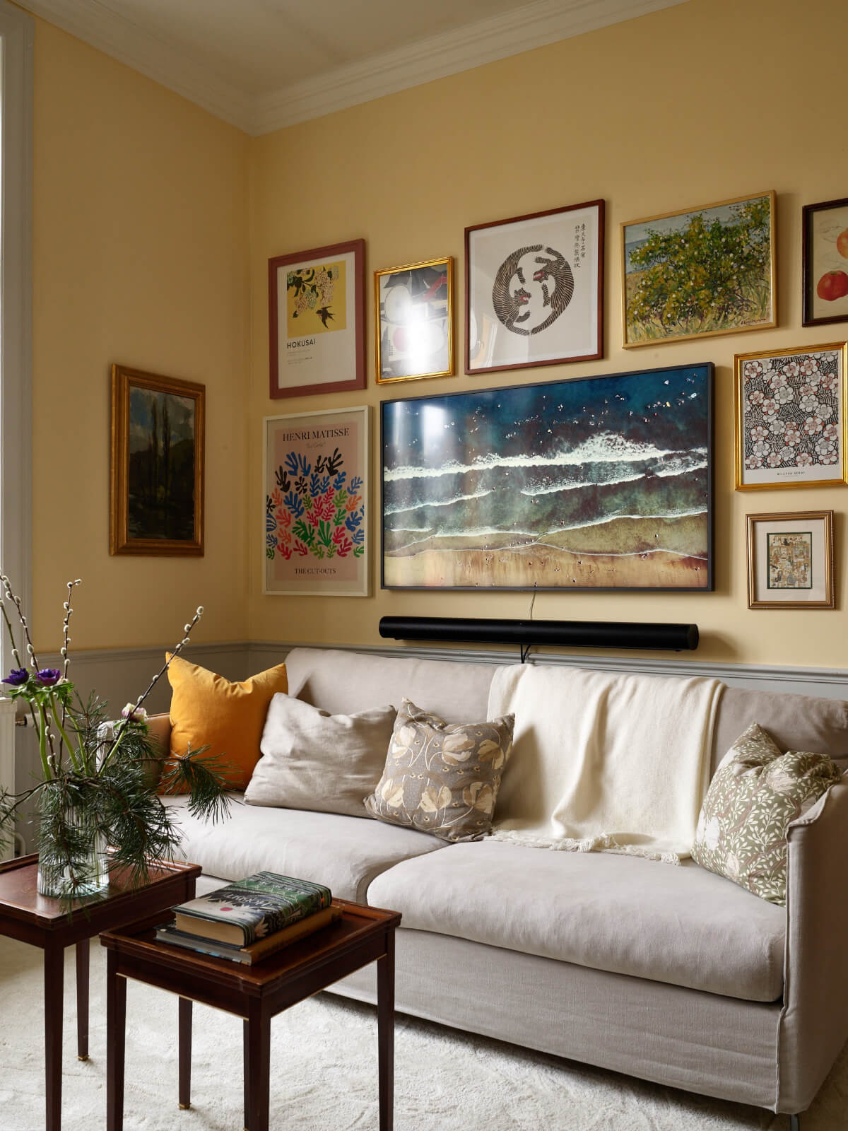 yellow living room gallery walls