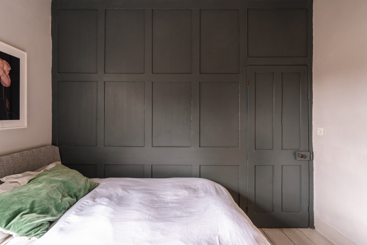 A Cozy Victorian Home Painted in Moody Blue and Gray Tones 24 dark gray paneled wall