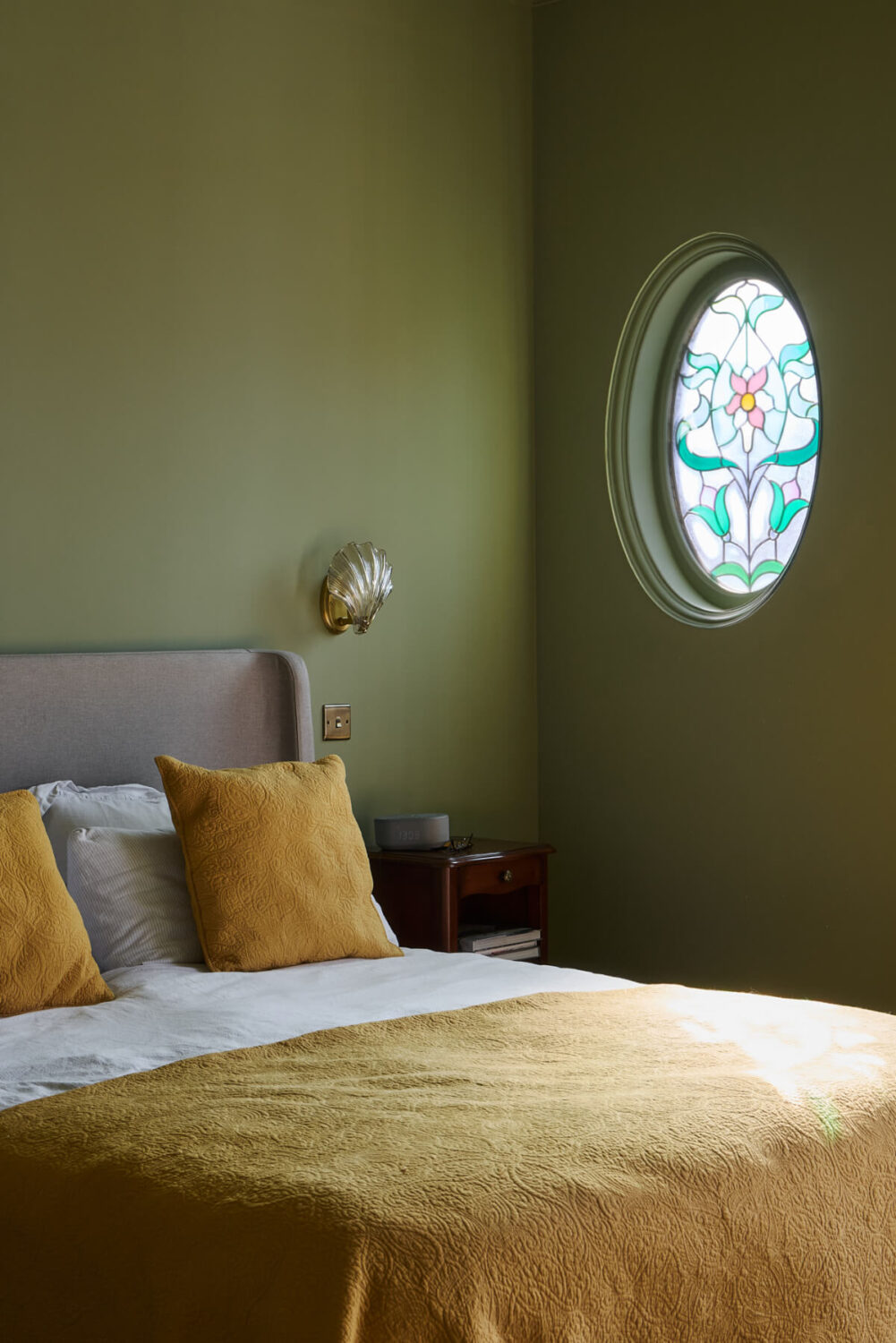 A Beautiful Extended Edwardian House Blends Period Features with Modern Design 18 green bedroom round stained glass window