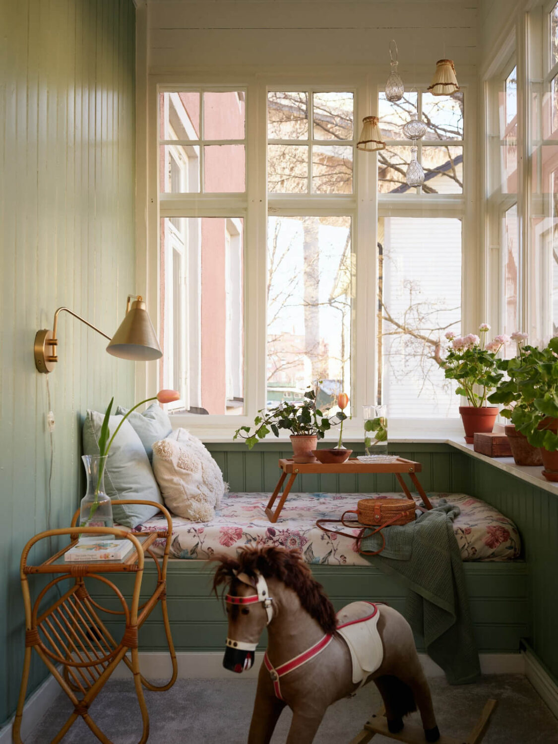 Light-Filled Rooms and a Charming Veranda in a Swedish Apartment 16 green paneled garden room window seat