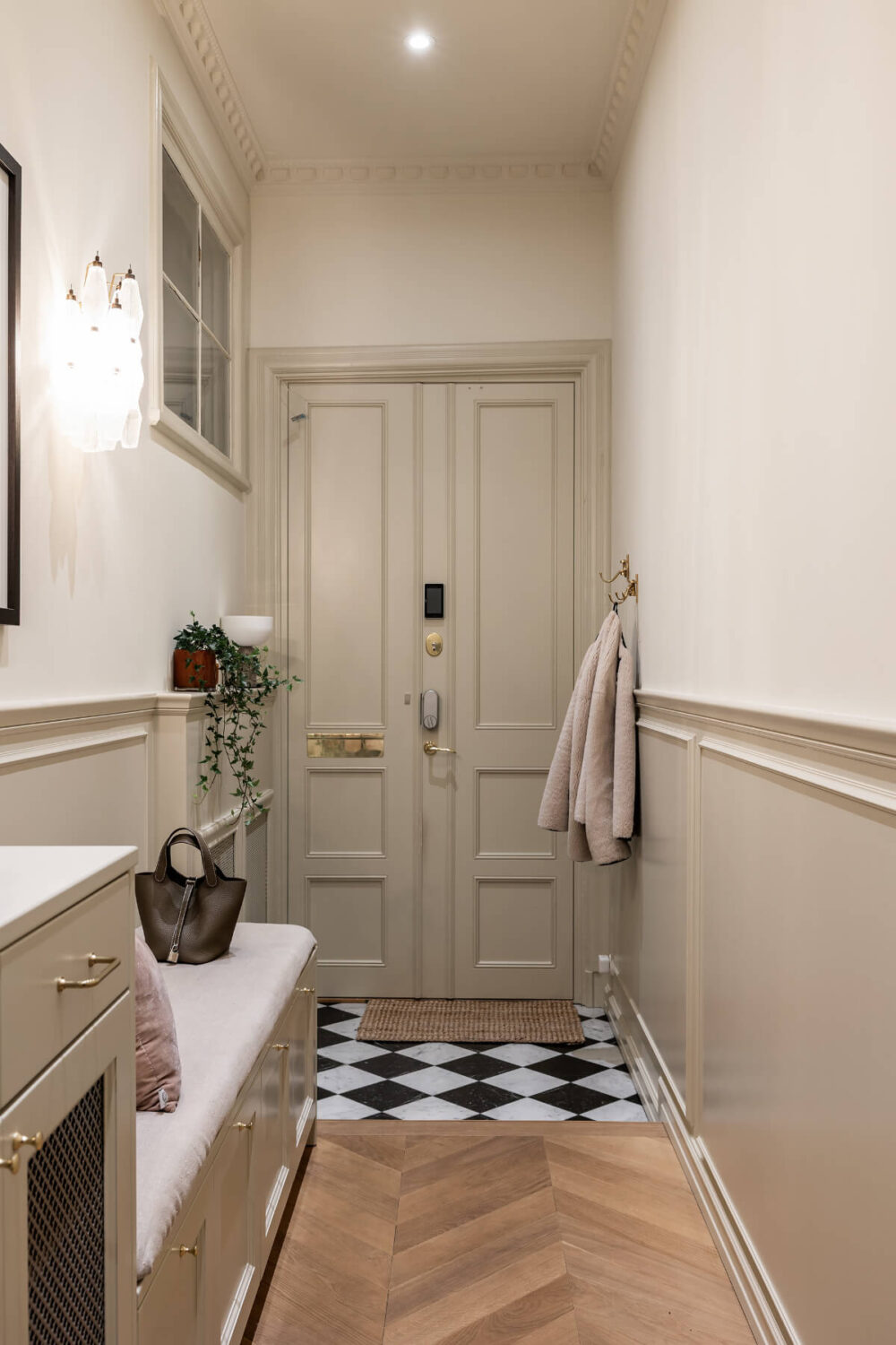 A Luxurious Stockholm Apartment with Period Features and a Blue Fireplace 24 hall with bench seating and checkerboard tile floor