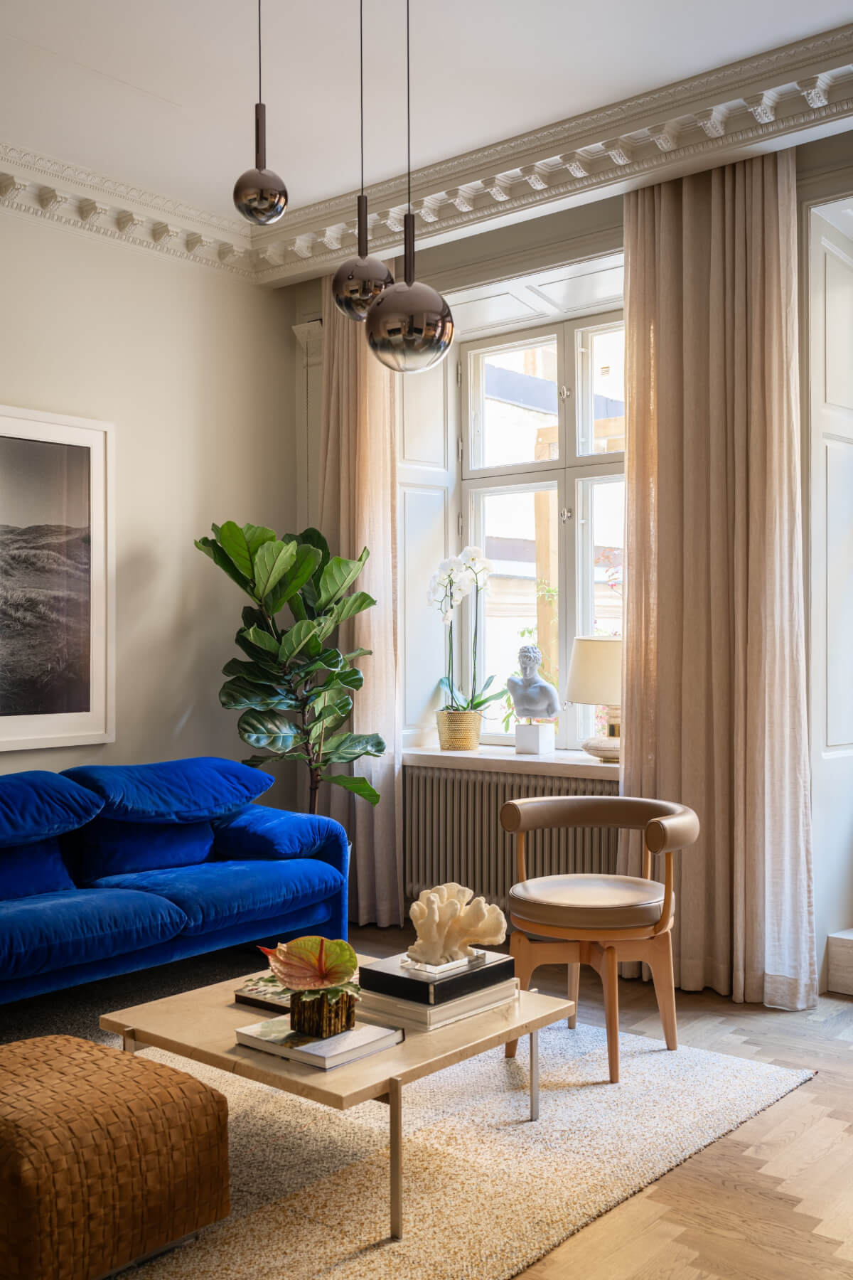 living room blue sofa period details gray walls