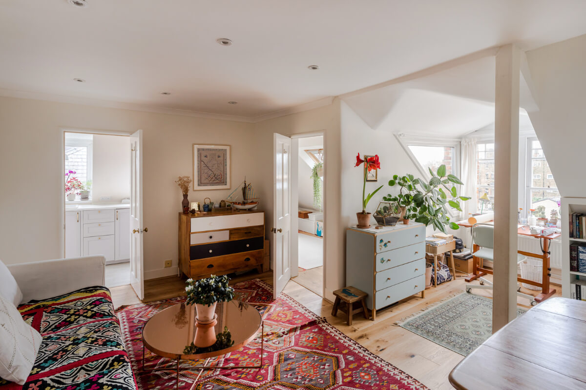 living room slanted ceiling colorful textiles dormer window