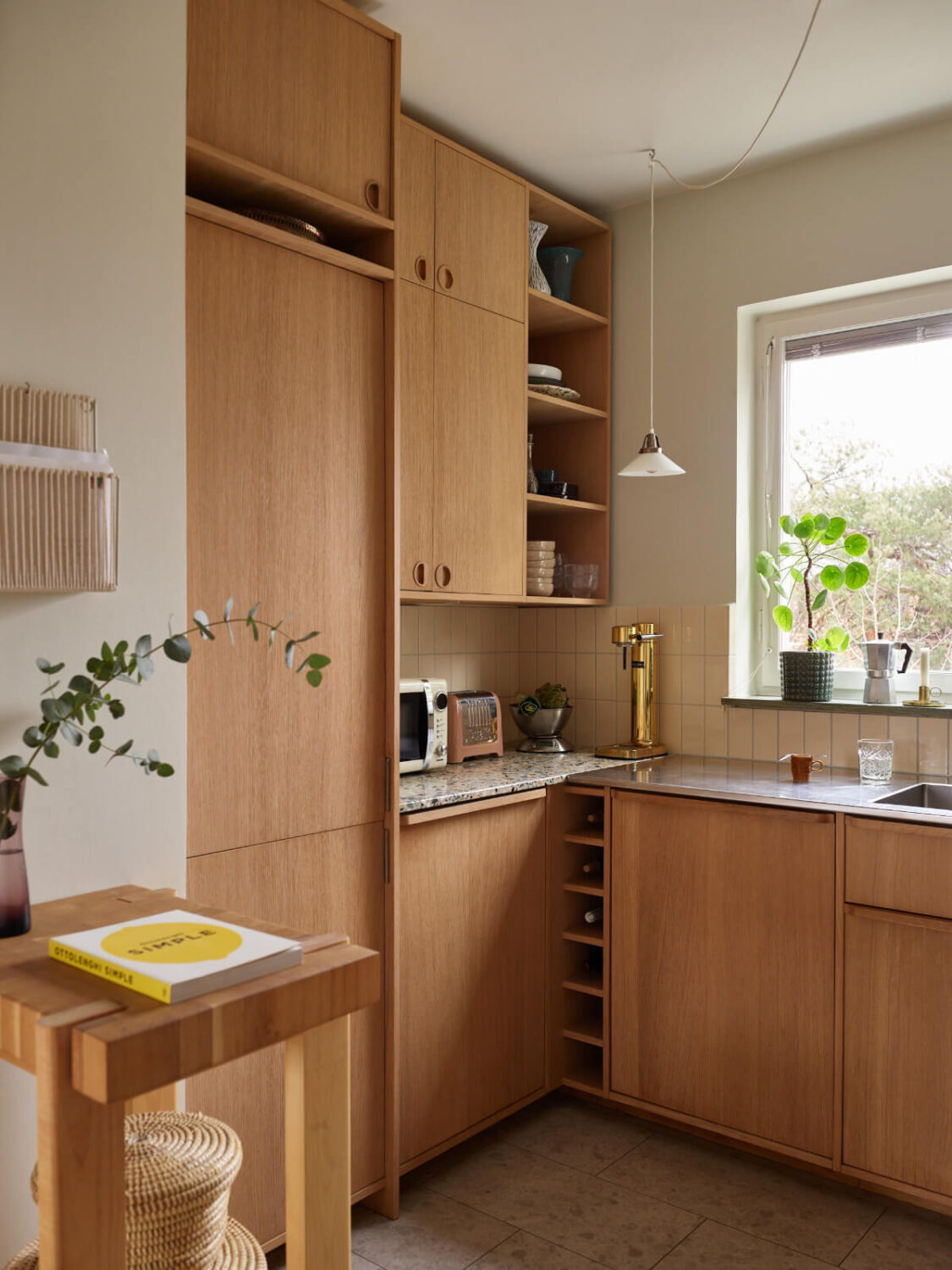 A Renovated 1940s Apartment with Colorful Bedrooms 14 oak kitchen with terrazzo countertop