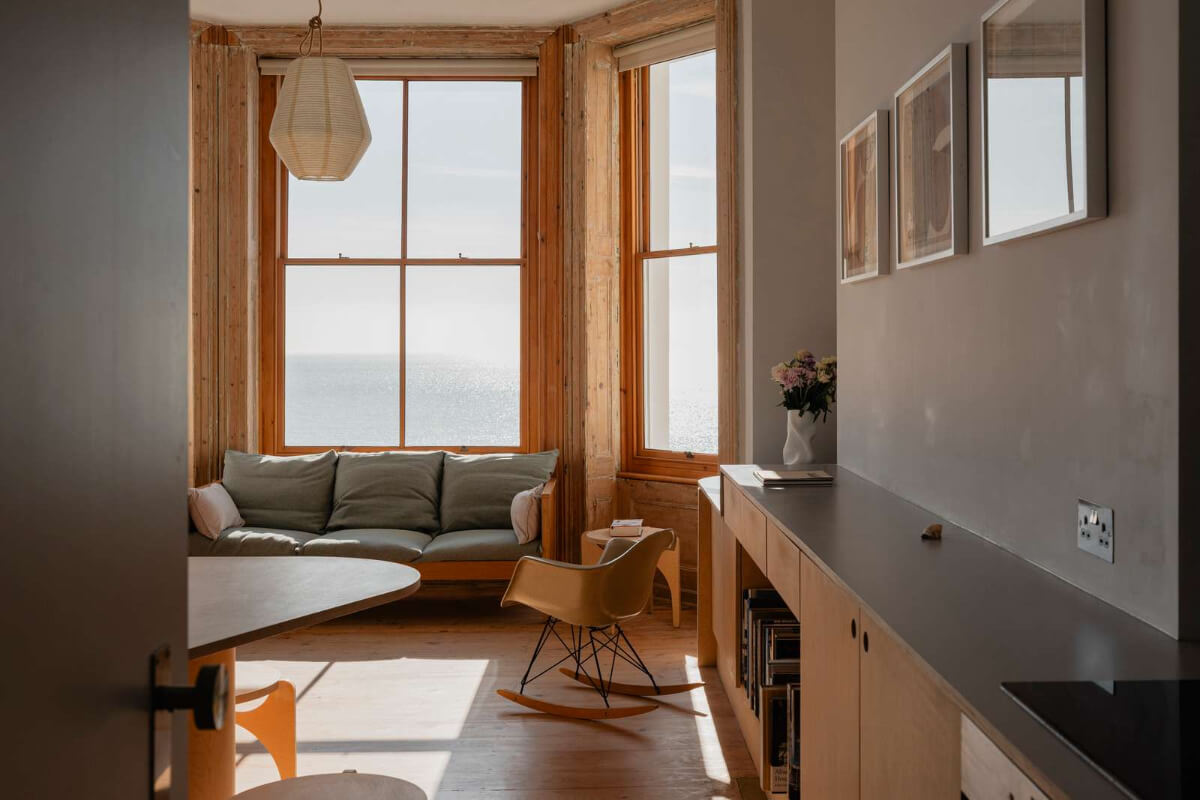 Bespoke Furniture in a Restored Seaside Apartment in England 5 open plan living space large window custom furniture