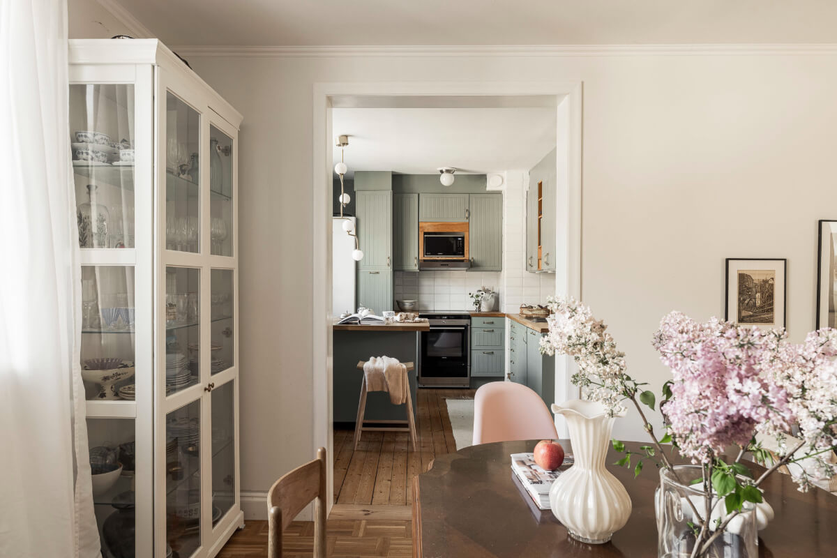A Swedish Duplex Apartment Inspired by A Danish Summer House 21 view into green kitchen