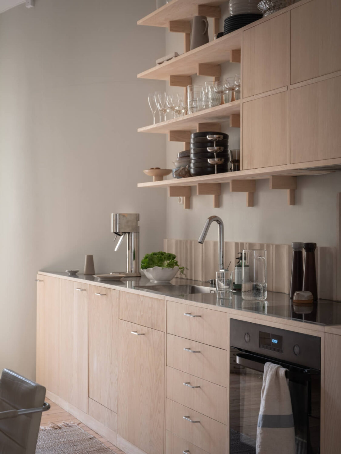 A Calm Color Palette in a Charming Swedish Apartment 12 wooden kitchen shelves