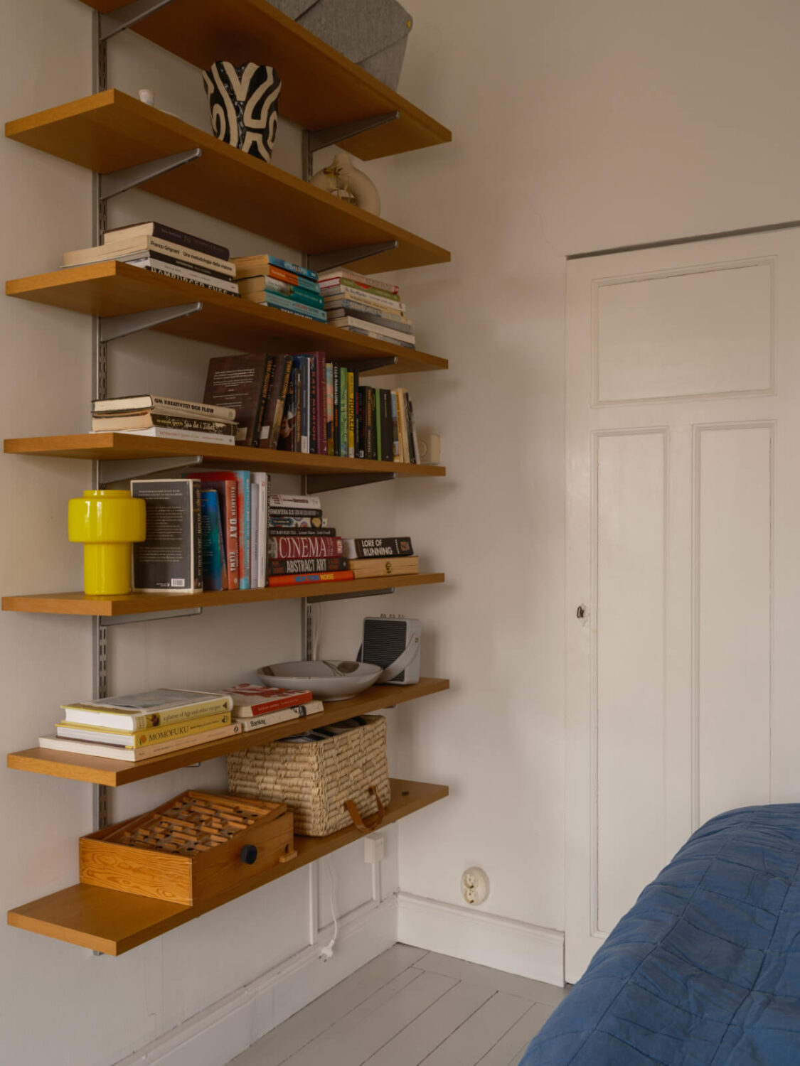 A Studio Apartment with an Exposed Brick Wall 12 wooden shelves