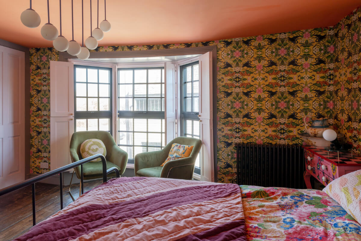 Colorful Design and Historic Features in a Charming English Home 16 colorful wallpaper bedroom bay window built-in wardrobes nordroom