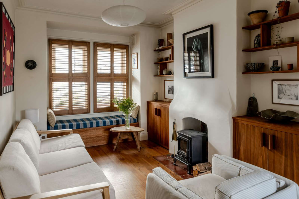 Reclaimed Materials and Custom Storage in a Serene London Home 2 cozy living room built-in storage wood burner