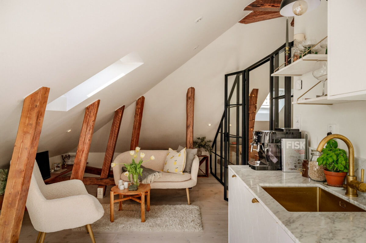 A Bright Attic Apartment with Exposed Beams and a Roof Terrace 2 exposed beams slanted ceiling small living space