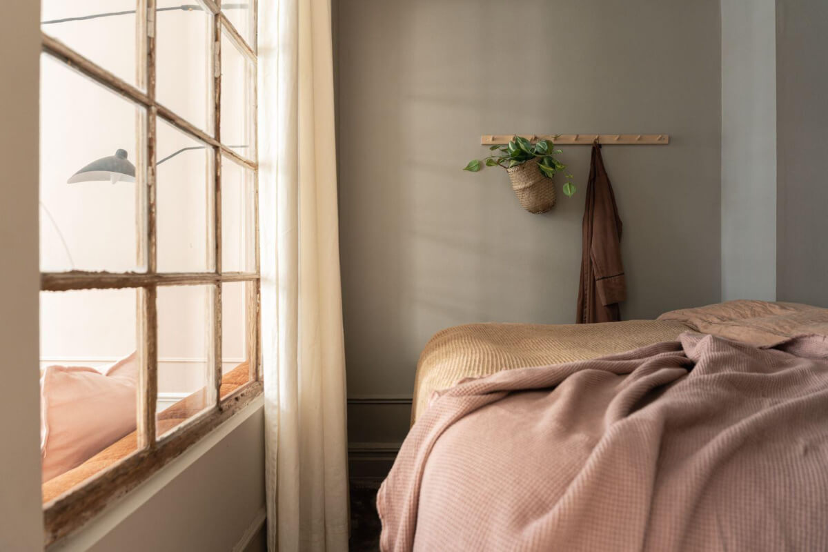 Warm Colors and Classic Elements in a Charming Studio Apartment 7 gray bedroom niche reclaimed window