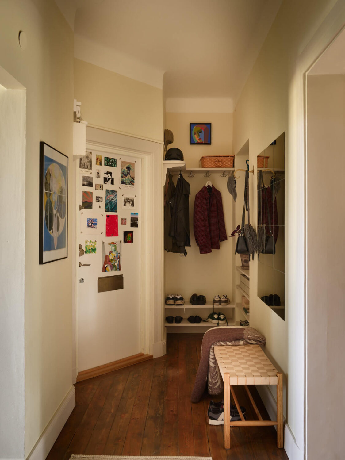 A Nature-Inspired Color Palette in a Stockholm Apartment 28 hall with niche for coat and shoe storage