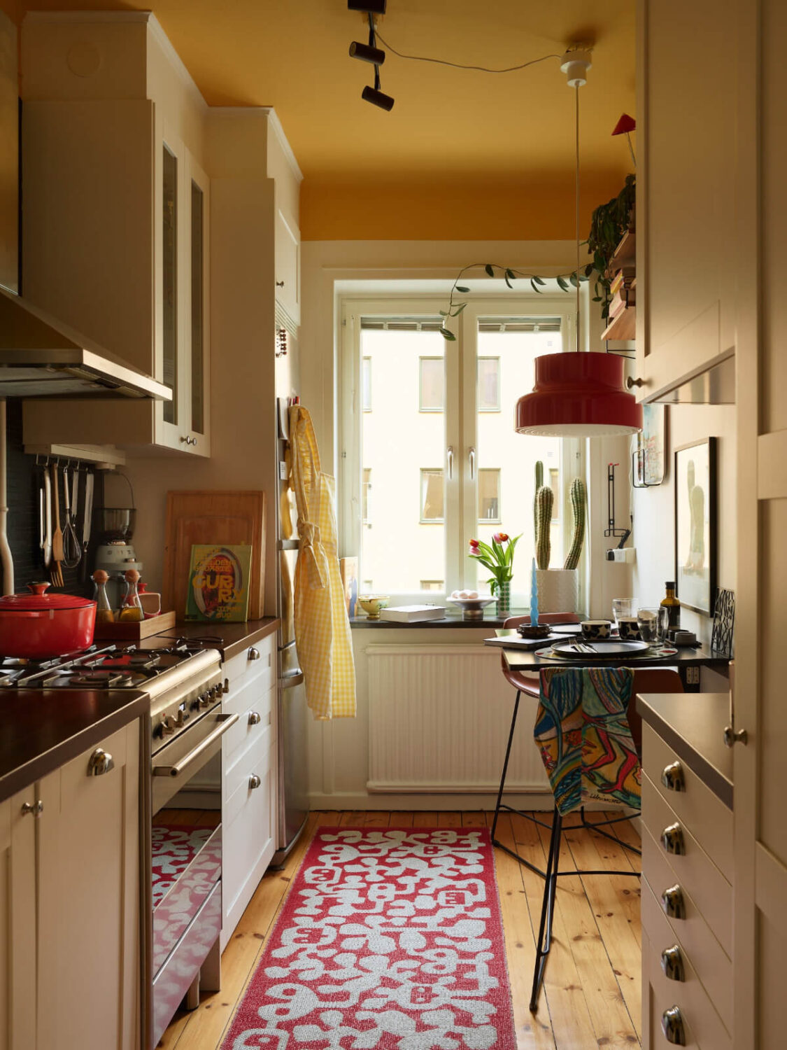 A Colorful Studio Apartment with Smart Storage and A Cozy Bed Niche 12 kitchen bright yellow ceiling small bar table