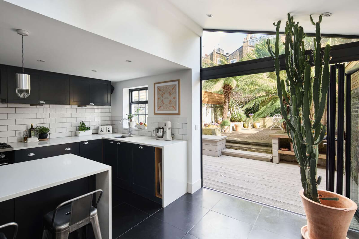 Light and Dark in a Spacious Victorian Townhouse in London 15 kitchen with glass doors to garden