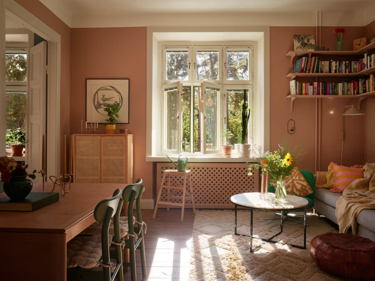 A Nature-Inspired Color Palette in a Stockholm Apartment 1 living room dark brown-beige walls bookshelves