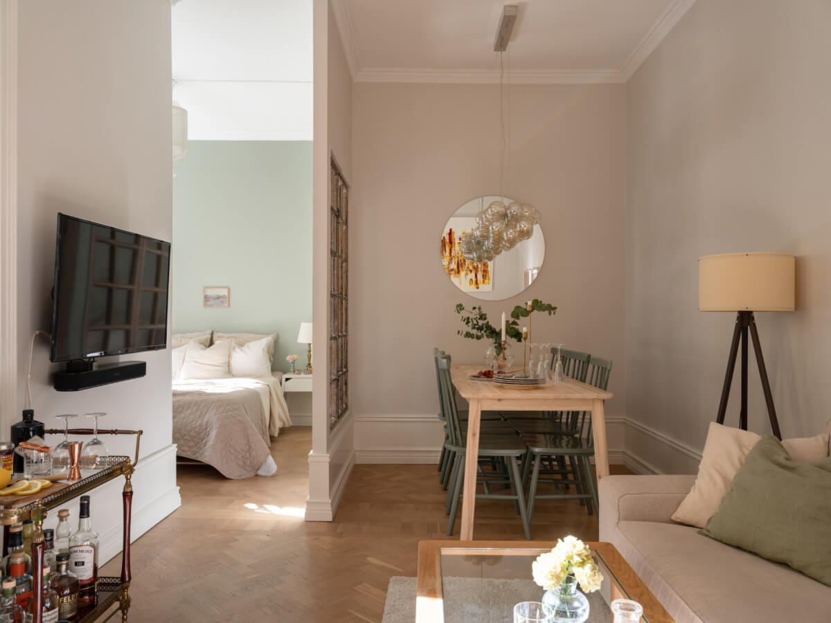 A Small Apartment with Green Color Accents and a Cozy Patio Terrace 1 open plan living space parquet floor