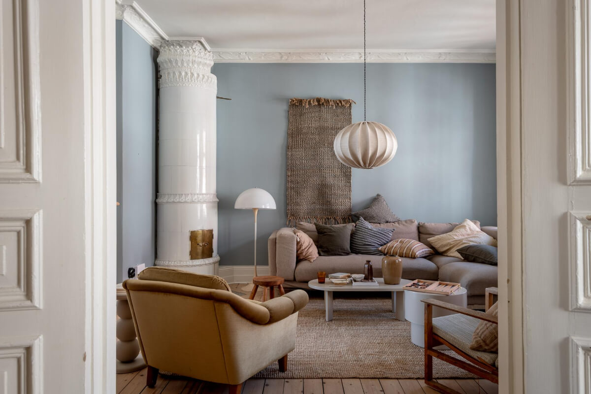 A Natural Color Palette, Period Features, & Grand Rooms in a Swedish Home 5 scandi living room wooden floorboards fireplace