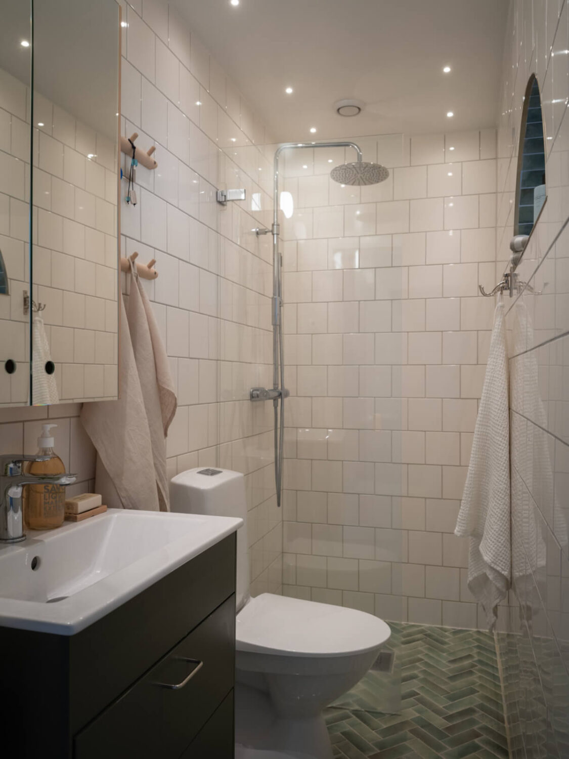 A Soft Color Palette and a Charming Kitchen in a Swedish Apartment 33 small bathroom herringbone floor tiles