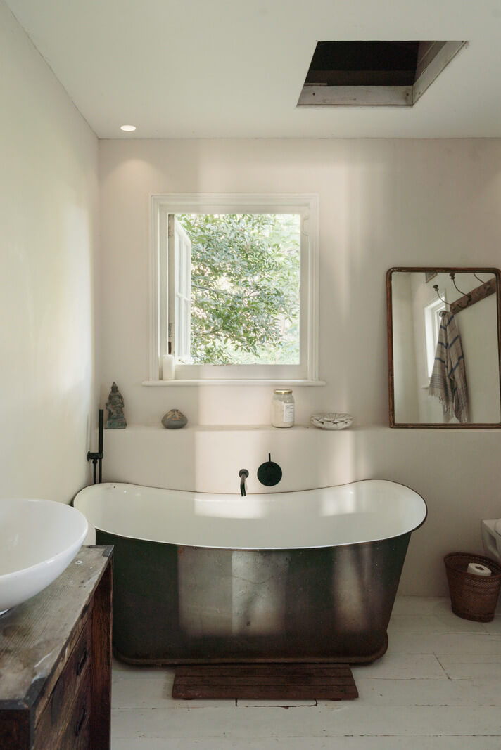 Grand, Light-Filled Spaces in a Gothic-Style English Coastal Home 22 bathroom freestanding bath white-painted floorboards