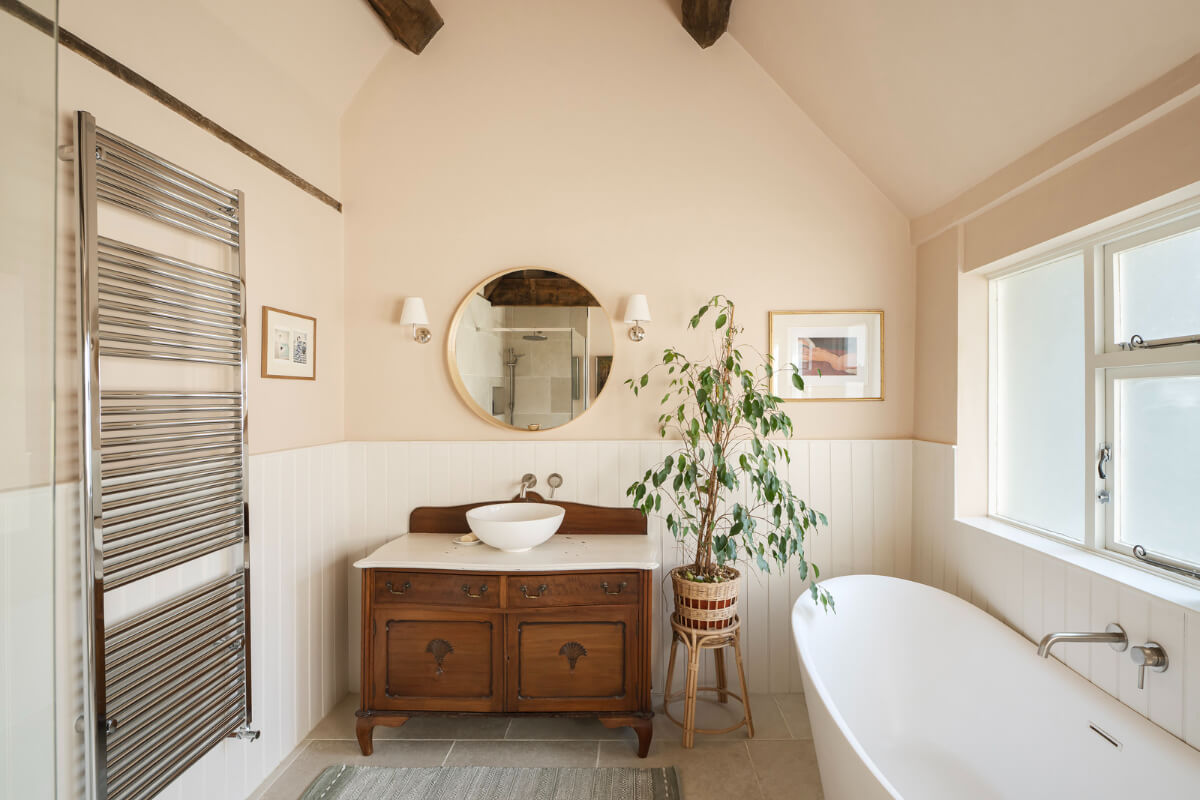 A Family Home with a Cheerful Color Palette in a Historic House 19 beige-pink walls bathroom freestanding bath antique vanity cabinet